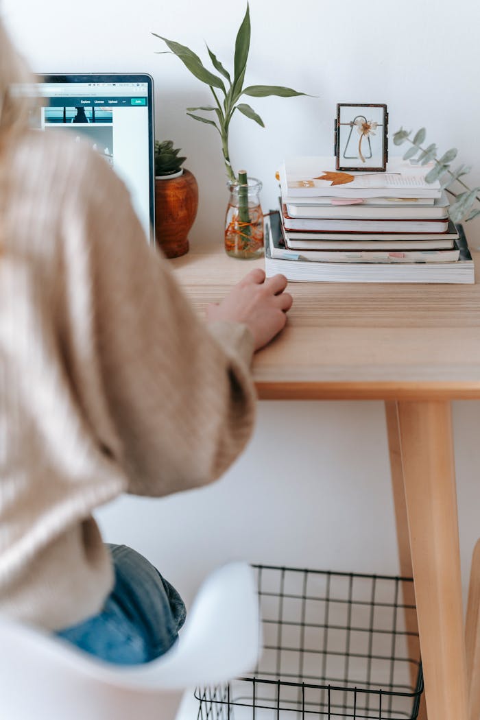 Unrecognizable freelancer working on laptop at home table